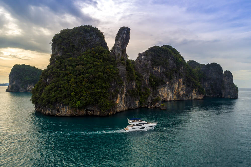 A Princess Yacht cruising on Phang Nga Bay waters in Thailand 